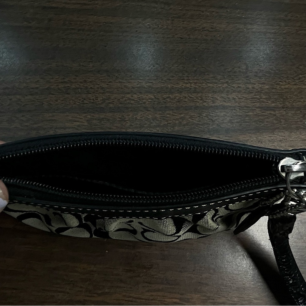 Signature Coach wristlet with strap.